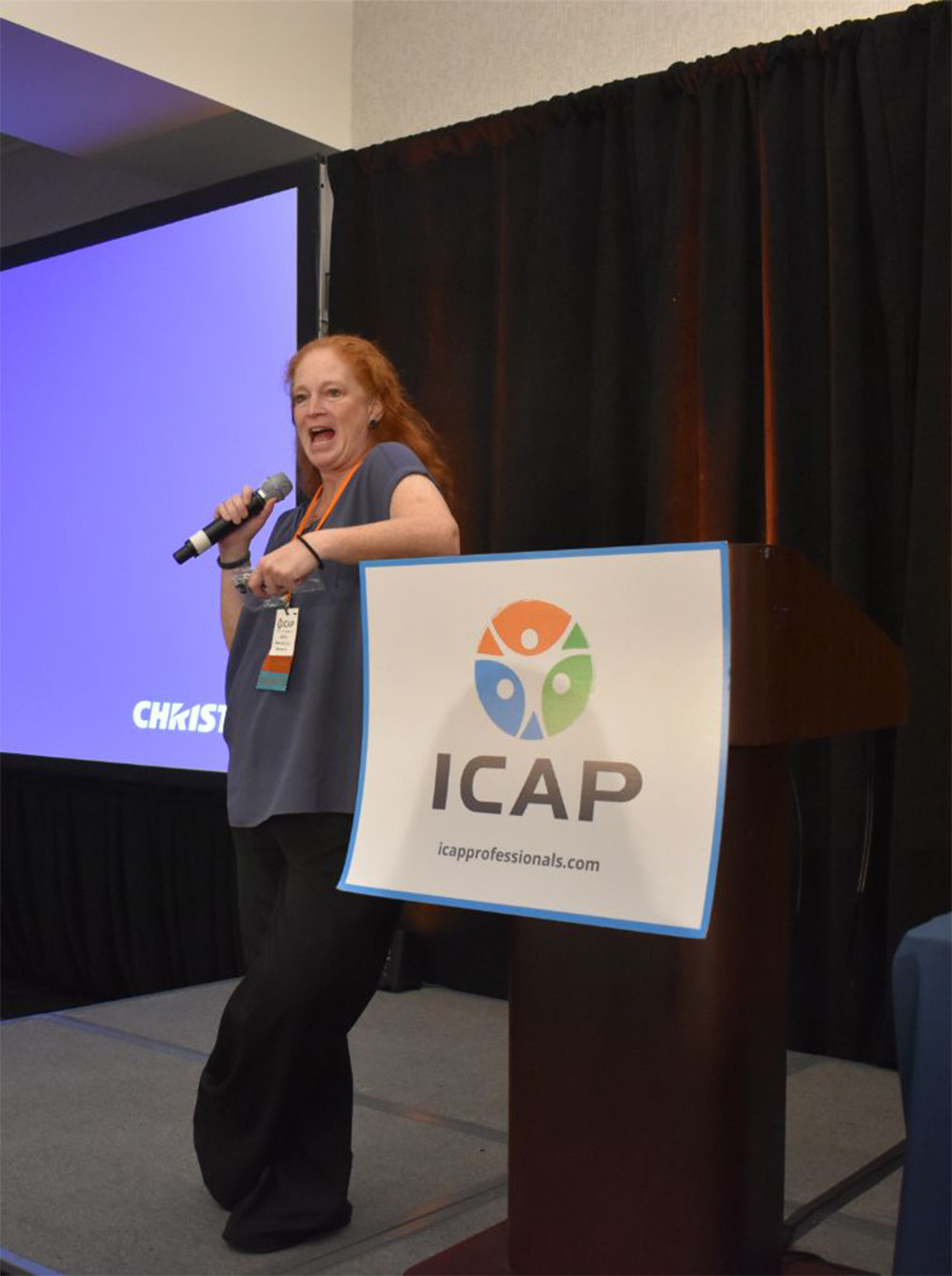 A speaker presenting at the 2024 ICAP conference.